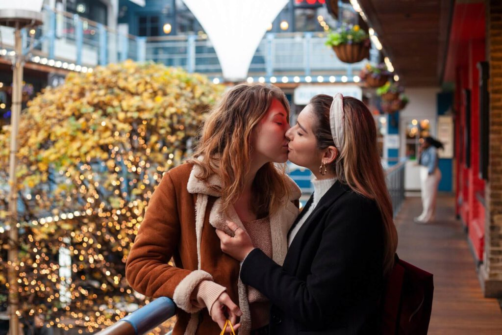 two women sharing a kiss