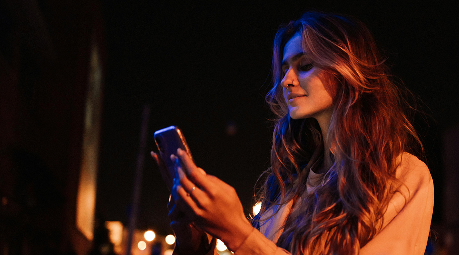 girl smiling to her phone notification