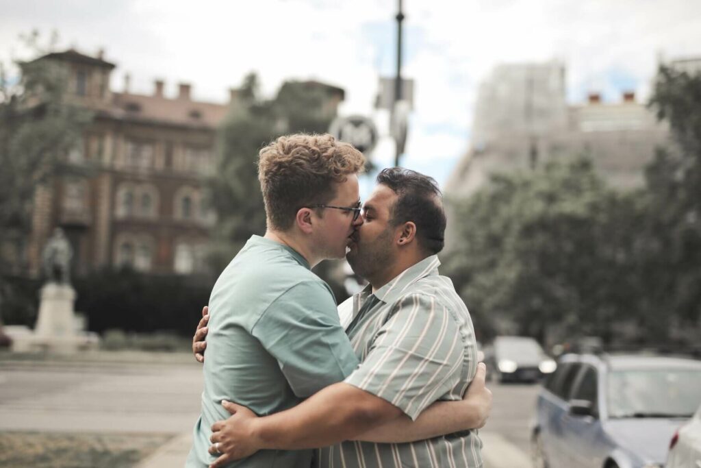 two men kissing in the street