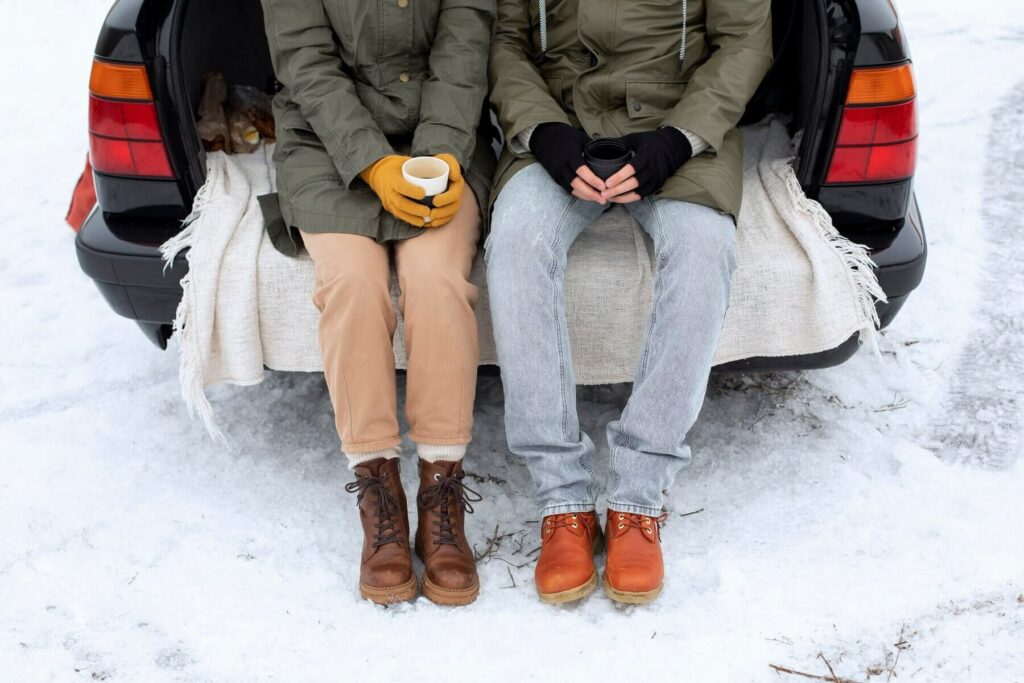 people sitting in the car trunk and holding a cup of tea