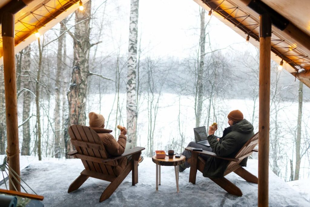 Couple enjoying their unique winter getaway in a cozy cabin